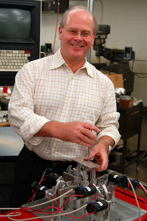 Joel Burdick with a robotic device that he developed to train a paralyzed rat’s rear legs to recover motor skill while stimulating the animal’s nervous system with electrodes implanted along the spine. Joel Burdick
